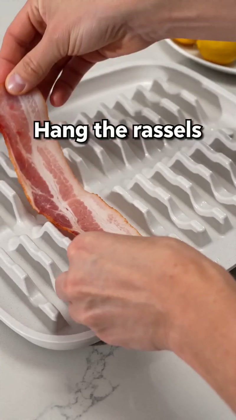 Strips hang vertically — fat drips into the tray below