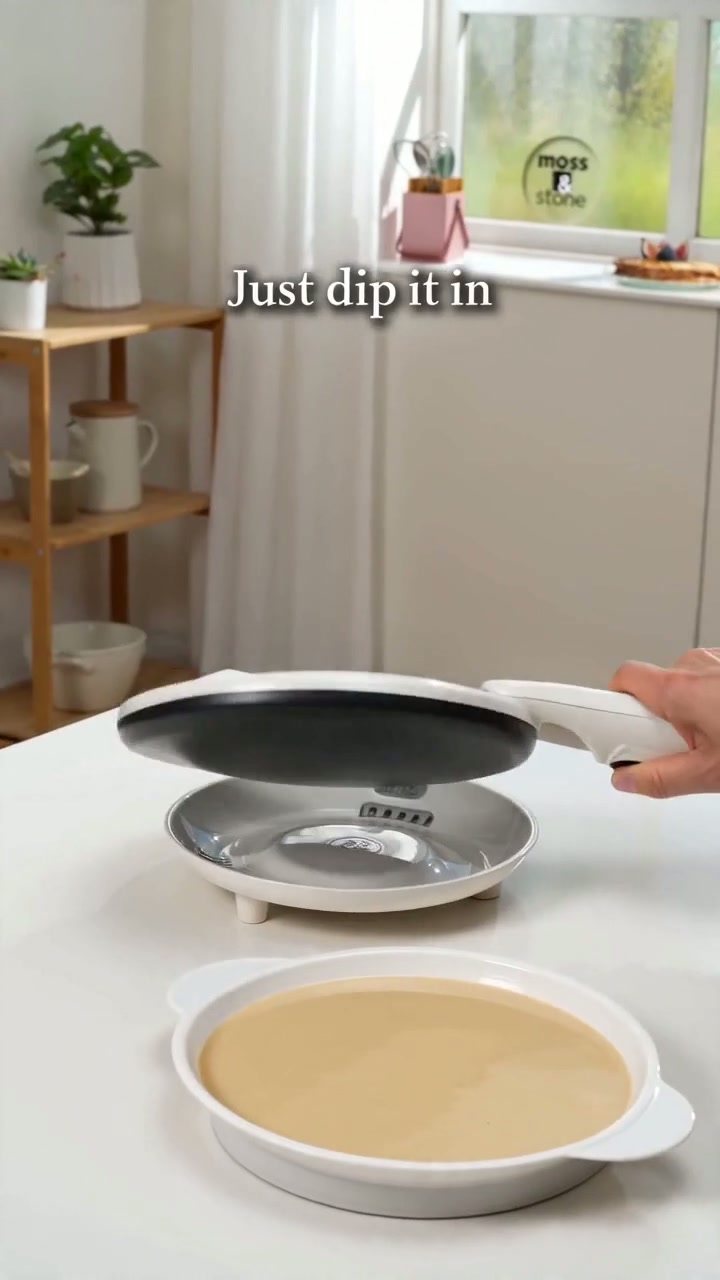 Dipping the hot plate into a dish of batter for an even, paper-thin layer