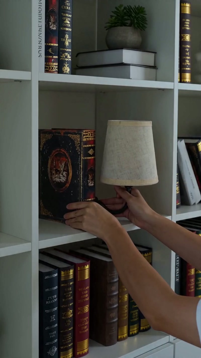 A book-shaped lamp that glows softly from its linen shade